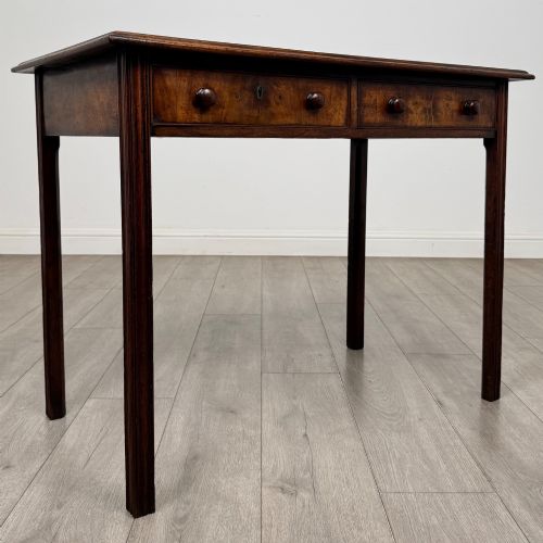 fig 7. A dark mahogany Georgian style writing table featuring two frieze drawers with turned wood knobs and straight legs.