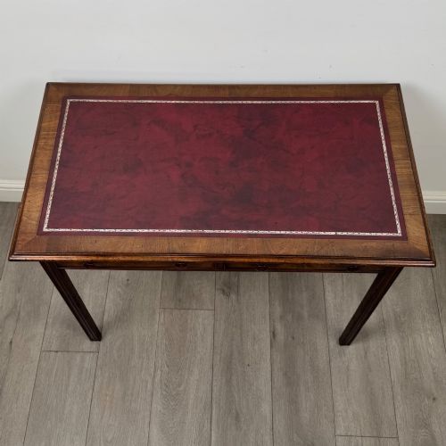 fig 8. A dark mahogany Georgian style writing table featuring two frieze drawers with turned wood knobs and straight legs.