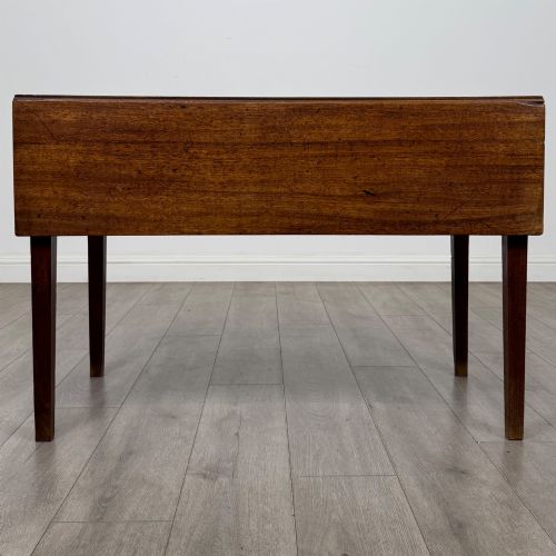 fig 1. A 19th-century Georgian style dark mahogany Pembroke side table with drop leaves, tapered square legs, and a single frieze drawer with a brass drop handle.