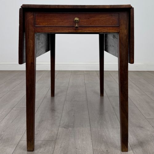 fig 3. A 19th-century Georgian style dark mahogany Pembroke side table with drop leaves, tapered square legs, and a single frieze drawer with a brass drop handle.