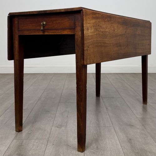 fig 5. A 19th-century Georgian style dark mahogany Pembroke side table with drop leaves, tapered square legs, and a single frieze drawer with a brass drop handle.
