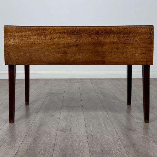 fig 6. A 19th-century Georgian style dark mahogany Pembroke side table with drop leaves, tapered square legs, and a single frieze drawer with a brass drop handle.