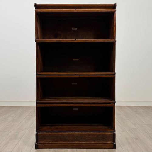 fig 1. An early twentieth-century oak four-tier Globe Wernicke stacking bookcase featuring glazed lift-and-slide doors.