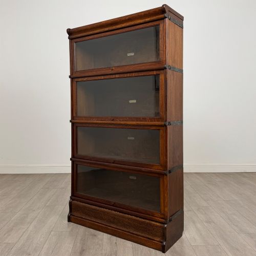 fig 2. An early twentieth-century oak four-tier Globe Wernicke stacking bookcase featuring glazed lift-and-slide doors.