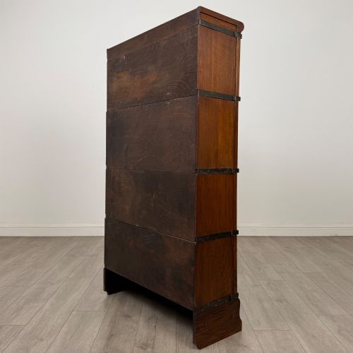fig 6. An early twentieth-century oak four-tier Globe Wernicke stacking bookcase featuring glazed lift-and-slide doors.