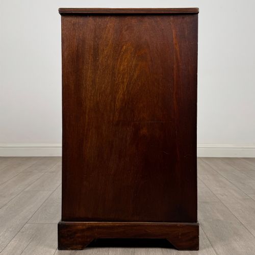fig 2. An eighteenth-century Georgian mahogany chest of drawers featuring two short upper drawers above two long lower drawers with oval brass handles.