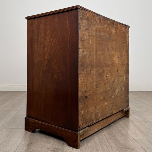 fig 3. An eighteenth-century Georgian mahogany chest of drawers featuring two short upper drawers above two long lower drawers with oval brass handles.