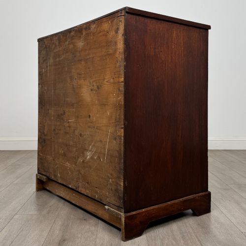 fig 5. An eighteenth-century Georgian mahogany chest of drawers featuring two short upper drawers above two long lower drawers with oval brass handles.