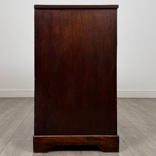 fig 6. An eighteenth-century Georgian mahogany chest of drawers featuring two short upper drawers above two long lower drawers with oval brass handles.