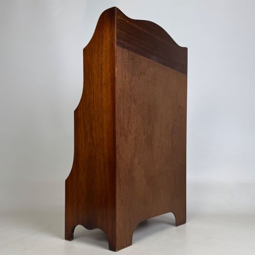 fig 4. A small 20th-century mahogany open bookcase with a shaped top gallery, two open shelves, and a single lower drawer fitted with brass ring handles.