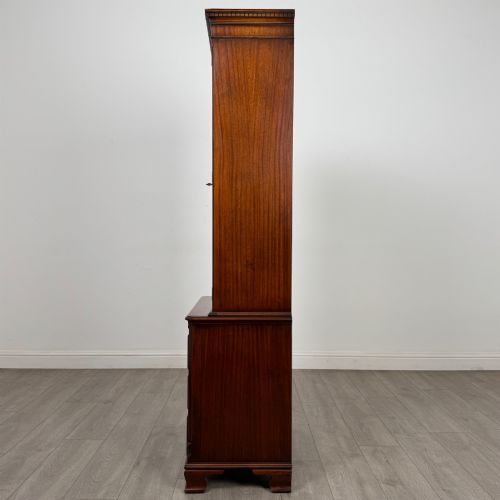 fig 4. A tall Georgian style mahogany bookcase featuring two glazed doors with gothic arch tracery above a lower section with three drawers.