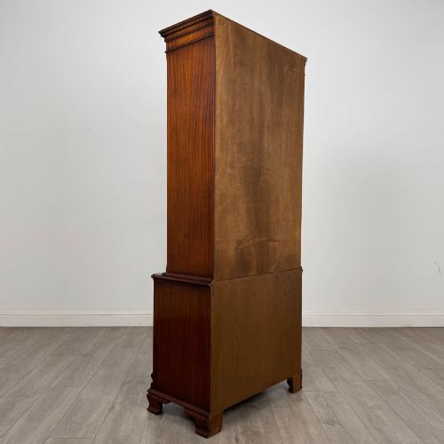 fig 5. A tall Georgian style mahogany bookcase featuring two glazed doors with gothic arch tracery above a lower section with three drawers.