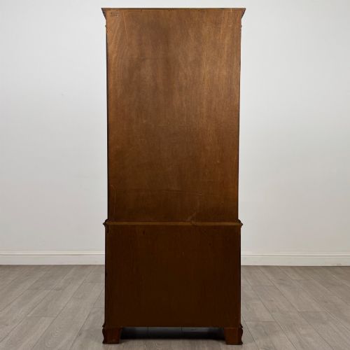 fig 6. A tall Georgian style mahogany bookcase featuring two glazed doors with gothic arch tracery above a lower section with three drawers.