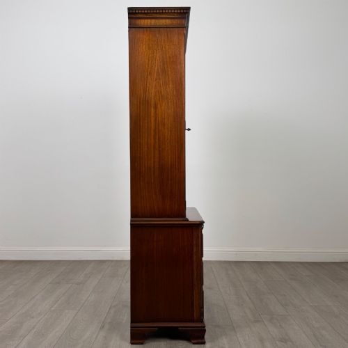 fig 8. A tall Georgian style mahogany bookcase featuring two glazed doors with gothic arch tracery above a lower section with three drawers.
