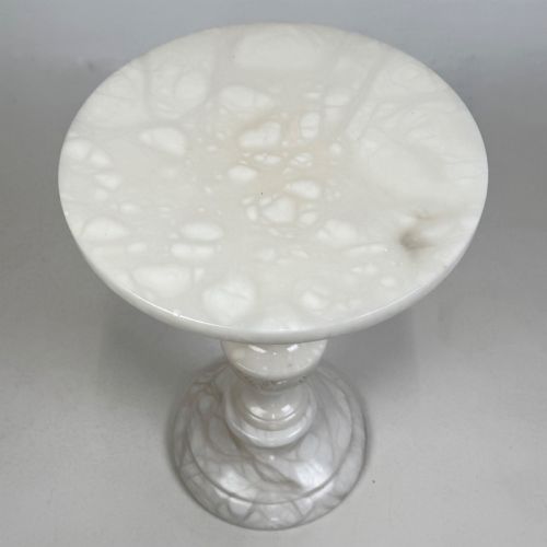 fig 3. A carved white alabaster side table featuring a circular top resting on a decorative turned pedestal stem and round base.