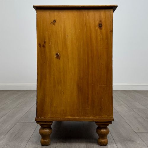 fig 2. A Victorian pine chest of drawers featuring a two over two drawer layout, turned wooden knobs, and turned feet.
