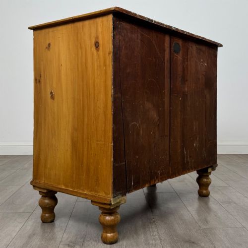 fig 3. A Victorian pine chest of drawers featuring a two over two drawer layout, turned wooden knobs, and turned feet.