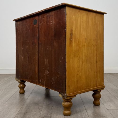 fig 5. A Victorian pine chest of drawers featuring a two over two drawer layout, turned wooden knobs, and turned feet.