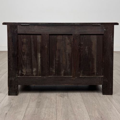 fig 4. A dark oak blanket box featuring three front panels decorated with detailed Gothic arch and shield carvings.
