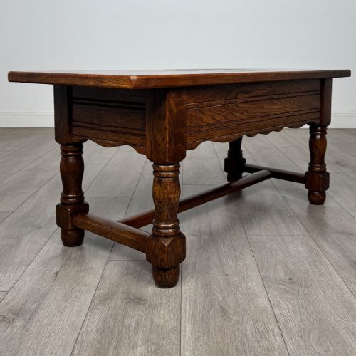 fig 3. A dark oak rectangular coffee table featuring two front drawers with wooden knob handles and turned baluster legs connected by a low stretcher.