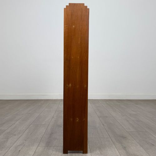 fig 2. An open-backed 20th-century Arts and Crafts walnut bookcase with four horizontal shelves and notched top end supports.