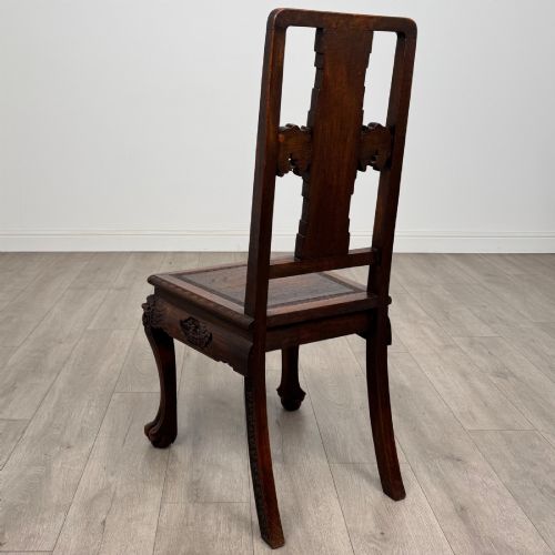 fig 4. A set of six antique dark rosewood Chinese dining chairs featuring carved back splats, scroll armrests on carvers, carved aprons, and claw feet.