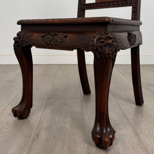 fig 6. A set of six antique dark rosewood Chinese dining chairs featuring carved back splats, scroll armrests on carvers, carved aprons, and claw feet.