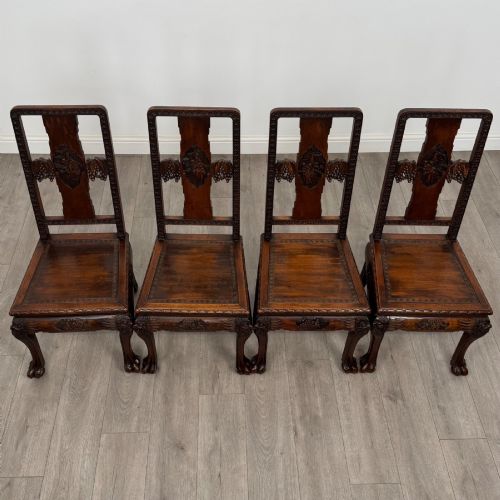 fig 8. A set of six antique dark rosewood Chinese dining chairs featuring carved back splats, scroll armrests on carvers, carved aprons, and claw feet.