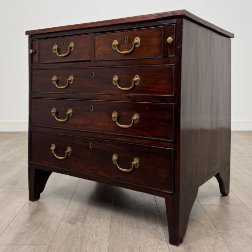 fig 1. An 18th-century Georgian dark mahogany chest of drawers with two short drawers over three long drawers and brass swan-neck handles.