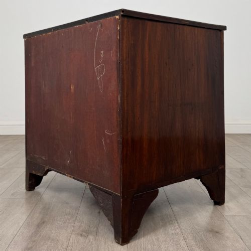 fig 5. An 18th-century Georgian dark mahogany chest of drawers with two short drawers over three long drawers and brass swan-neck handles.