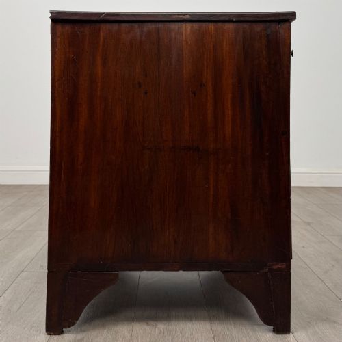 fig 6. An 18th-century Georgian dark mahogany chest of drawers with two short drawers over three long drawers and brass swan-neck handles.