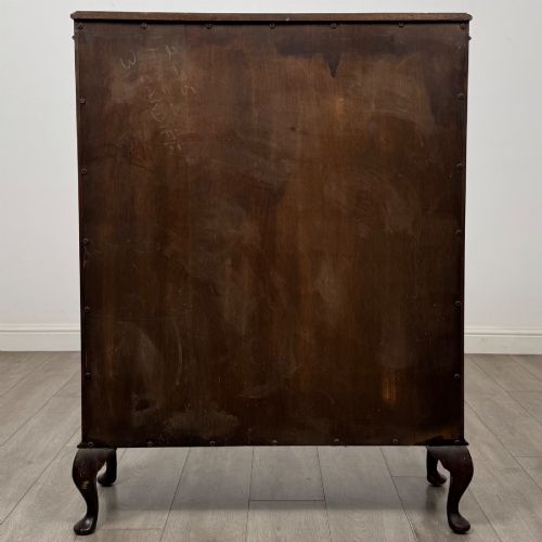 fig 5. An Edwardian mahogany display cabinet featuring astragal glazed doors with gothic arches, interior glass shelves, and cabriole legs.