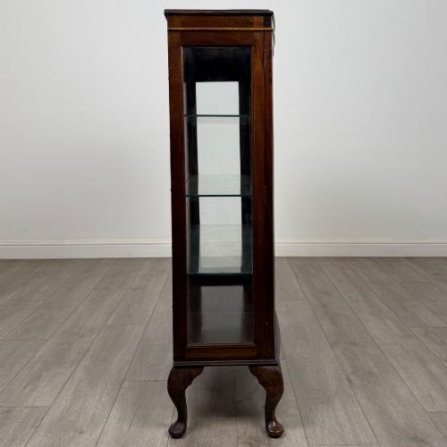 fig 7. An Edwardian mahogany display cabinet featuring astragal glazed doors with gothic arches, interior glass shelves, and cabriole legs.
