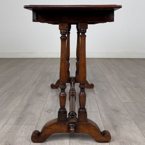 fig 2. A 19th-century Victorian mahogany side table featuring a rectangular top with a scalloped apron, turned twin-column supports, a central turned stretcher, and curved feet.
