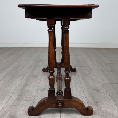 fig 6. A 19th-century Victorian mahogany side table featuring a rectangular top with a scalloped apron, turned twin-column supports, a central turned stretcher, and curved feet.
