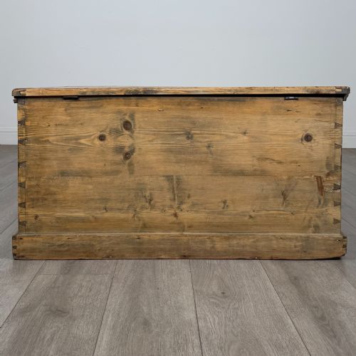 fig 4. A rectangular nineteenth-century rustic pine blanket box with visible hand-cut dovetail joints, a central keyhole escutcheon, and a moulded base.