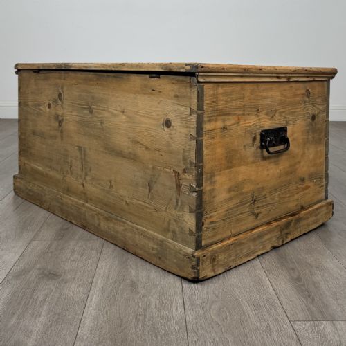 fig 5. A rectangular nineteenth-century rustic pine blanket box with visible hand-cut dovetail joints, a central keyhole escutcheon, and a moulded base.
