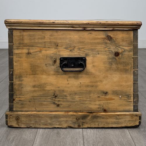 fig 6. A rectangular nineteenth-century rustic pine blanket box with visible hand-cut dovetail joints, a central keyhole escutcheon, and a moulded base.
