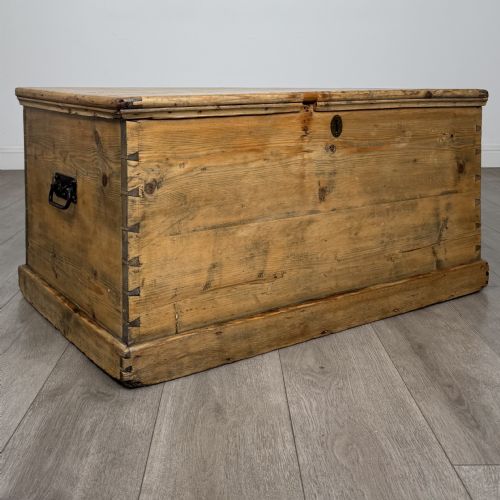 fig 7. A rectangular nineteenth-century rustic pine blanket box with visible hand-cut dovetail joints, a central keyhole escutcheon, and a moulded base.