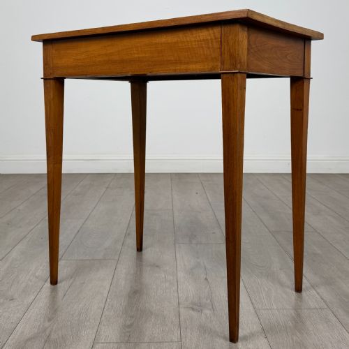 fig 1. An antique early 20th-century walnut side table with a flat rectangular top, plain frieze, and four square tapered legs.