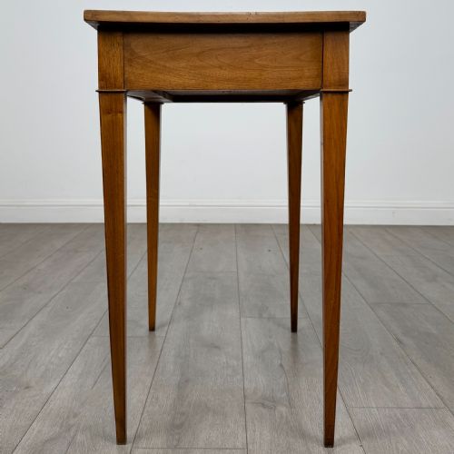 fig 2. An antique early 20th-century walnut side table with a flat rectangular top, plain frieze, and four square tapered legs.