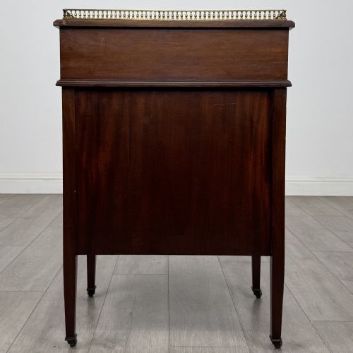 fig 3. An Edwardian mahogany Davenport desk featuring satinwood crossbanding, a top brass gallery rail, and castors on the base.