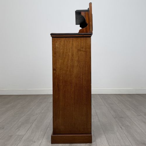 fig 3. An Edwardian inlaid mahogany cabinet featuring an upper mirrored gallery, two marquetry panels with shell motifs, and a glazed lower door section.