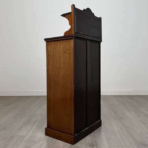 fig 4. An Edwardian inlaid mahogany cabinet featuring an upper mirrored gallery, two marquetry panels with shell motifs, and a glazed lower door section.