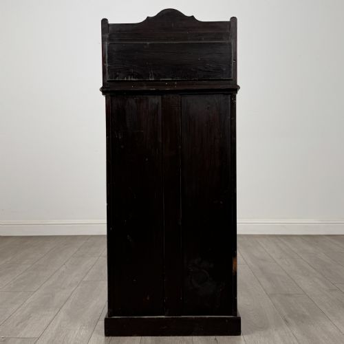 fig 5. An Edwardian inlaid mahogany cabinet featuring an upper mirrored gallery, two marquetry panels with shell motifs, and a glazed lower door section.