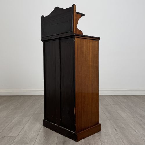 fig 6. An Edwardian inlaid mahogany cabinet featuring an upper mirrored gallery, two marquetry panels with shell motifs, and a glazed lower door section.