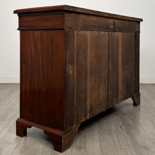 fig 4. A Victorian mahogany cupboard featuring two drawers with brass drop handles above two panelled doors, resting on bracket feet.