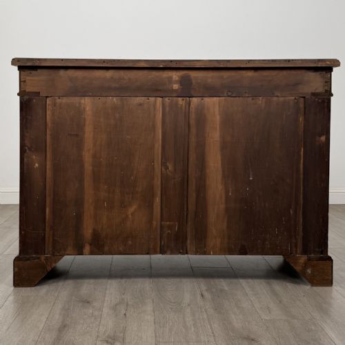 fig 5. A Victorian mahogany cupboard featuring two drawers with brass drop handles above two panelled doors, resting on bracket feet.