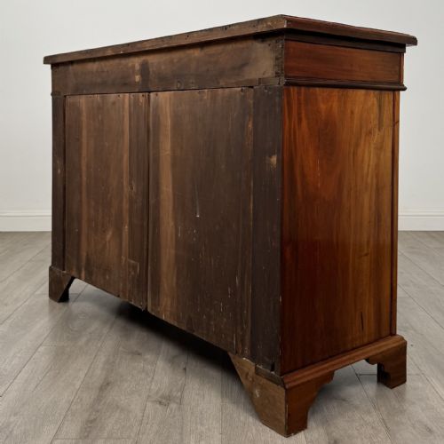 fig 6. A Victorian mahogany cupboard featuring two drawers with brass drop handles above two panelled doors, resting on bracket feet.