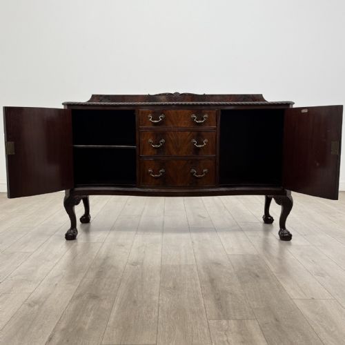fig 1. An Edwardian mahogany sideboard featuring three central drawers flanked by two cupboard doors, resting on cabriole legs with claw and ball feet.